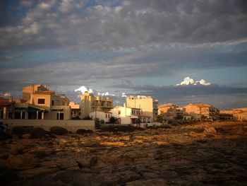 Buildings against cloudy sky