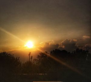 Silhouette trees against sky during sunset