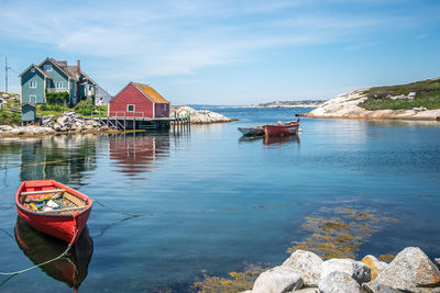 Peggy's cove, nova scotia, canada. beautiful summer day with blue sky, ocean waters, and green grass