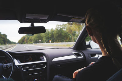 Side view of woman in car