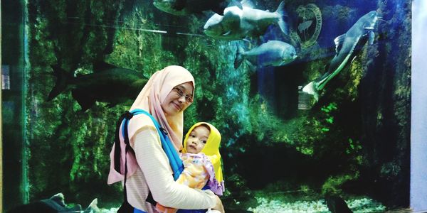 Portrait of mother with baby girl at aquarium