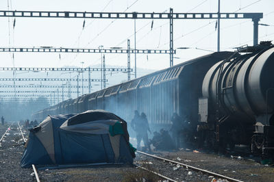 View of train with people by portable tent