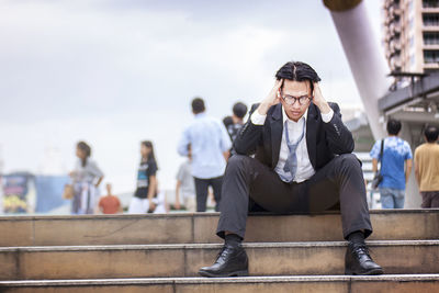 Man sitting on railing