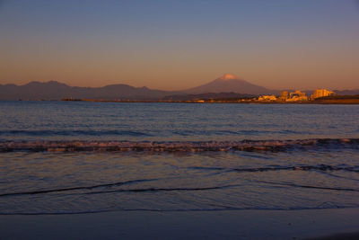 Scenic view of sea against clear sky during sunset