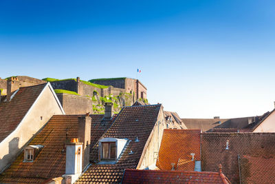 Low angle view of residential buildings against clear blue sky