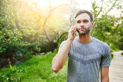Portrait of young man standing outdoors