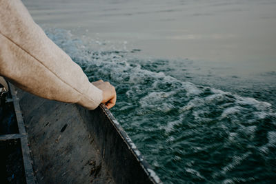 Midsection of man holding sea