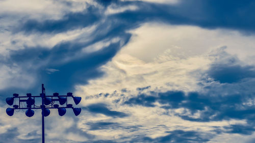 Low angle view of information sign against sky during sunset