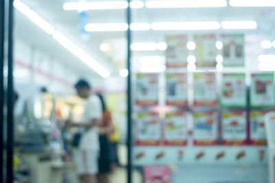 Defocused image of man standing on glass