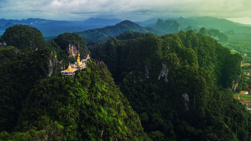 Scenic view of trees and mountains against sky