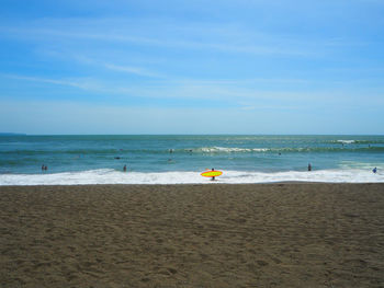 Scenic view of beach against blue sky