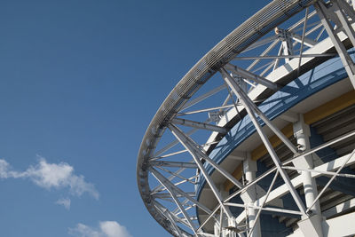 Low angle view of metallic structure against clear blue sky, worldcup stadium