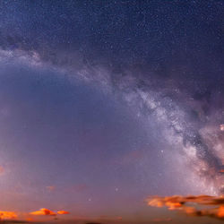 Scenic view of snowcapped mountains against sky at night