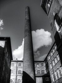 Low angle view of building against cloudy sky