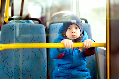 Schoolboy rides on the bus. sad child in society