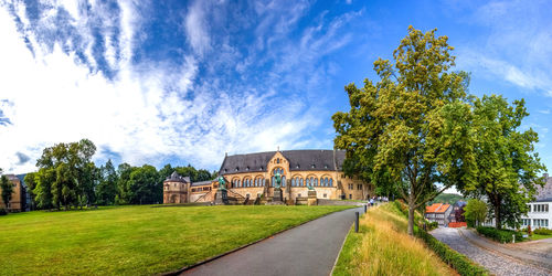 Panoramic view of trees and buildings against sky