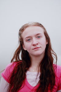 Portrait of beautiful young woman over white background