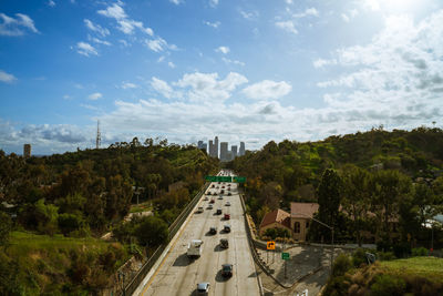 High angle view of road amidst trees against sky