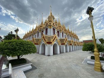 View of temple building against cloudy sky