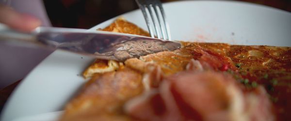 Close-up of hand holding ice cream in plate