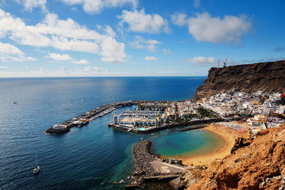 Townscape and mountains by atlantic ocean at gran canaria island