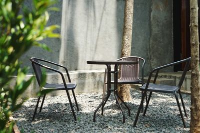 Empty chairs and table in park