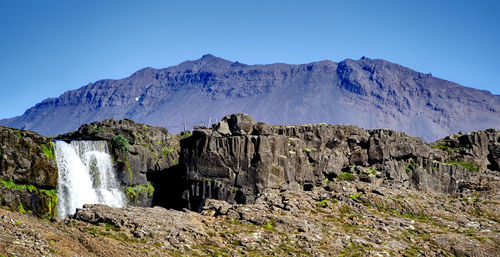Scenic view of rocky mountains against clear blue sky