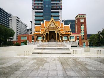 Statue in temple against sky in city