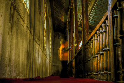 Side view of people walking in building