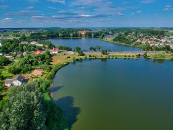 High angle view of lake and buildings against sky