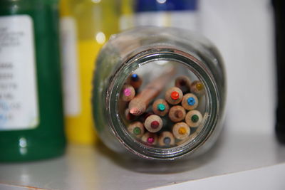 Close-up of colorful pencils in jar on table