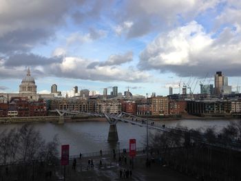 View of cityscape against cloudy sky