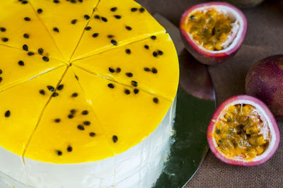 High angle view of cake with passion fruits on table