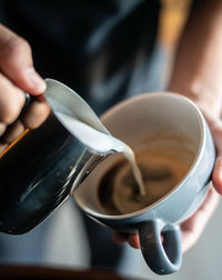 Hand holding coffee cup