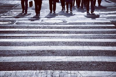 Low section of people walking on road