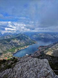 Scenic view of sea and mountains against sky