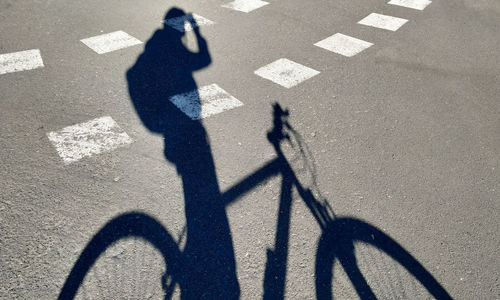 Shadow of man on road