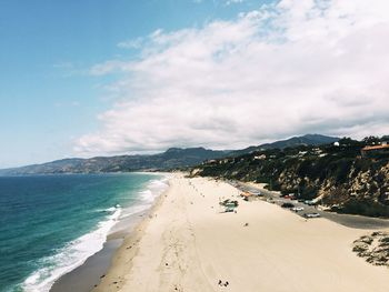 Scenic view of beach and mountains against sky