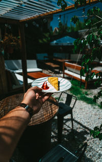 Midsection of person holding food on table