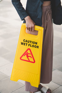 Low section of man standing on road