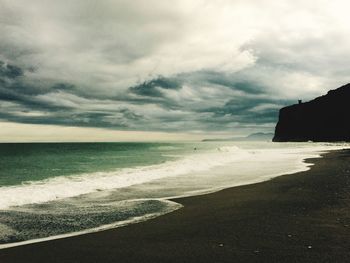 Scenic view of sea against cloudy sky