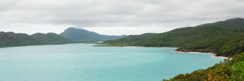 Scenic view of sea and mountains against sky