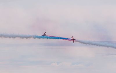 Low angle view of airshow against sky