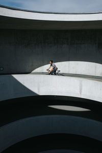 Man riding bicycle on bridge