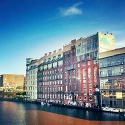 Buildings in city against clear sky