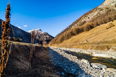 Scenic view of snowcapped mountains against blue sky