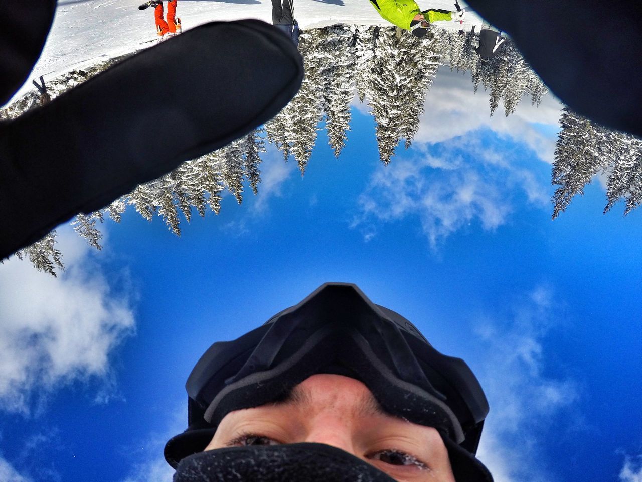 LOW ANGLE VIEW OF MAN AGAINST BLUE SKY AND TREES