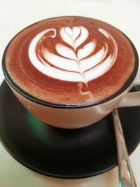 Close-up of cappuccino served on table