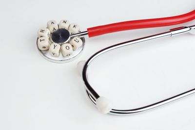 High angle view of eyeglasses on table against white background