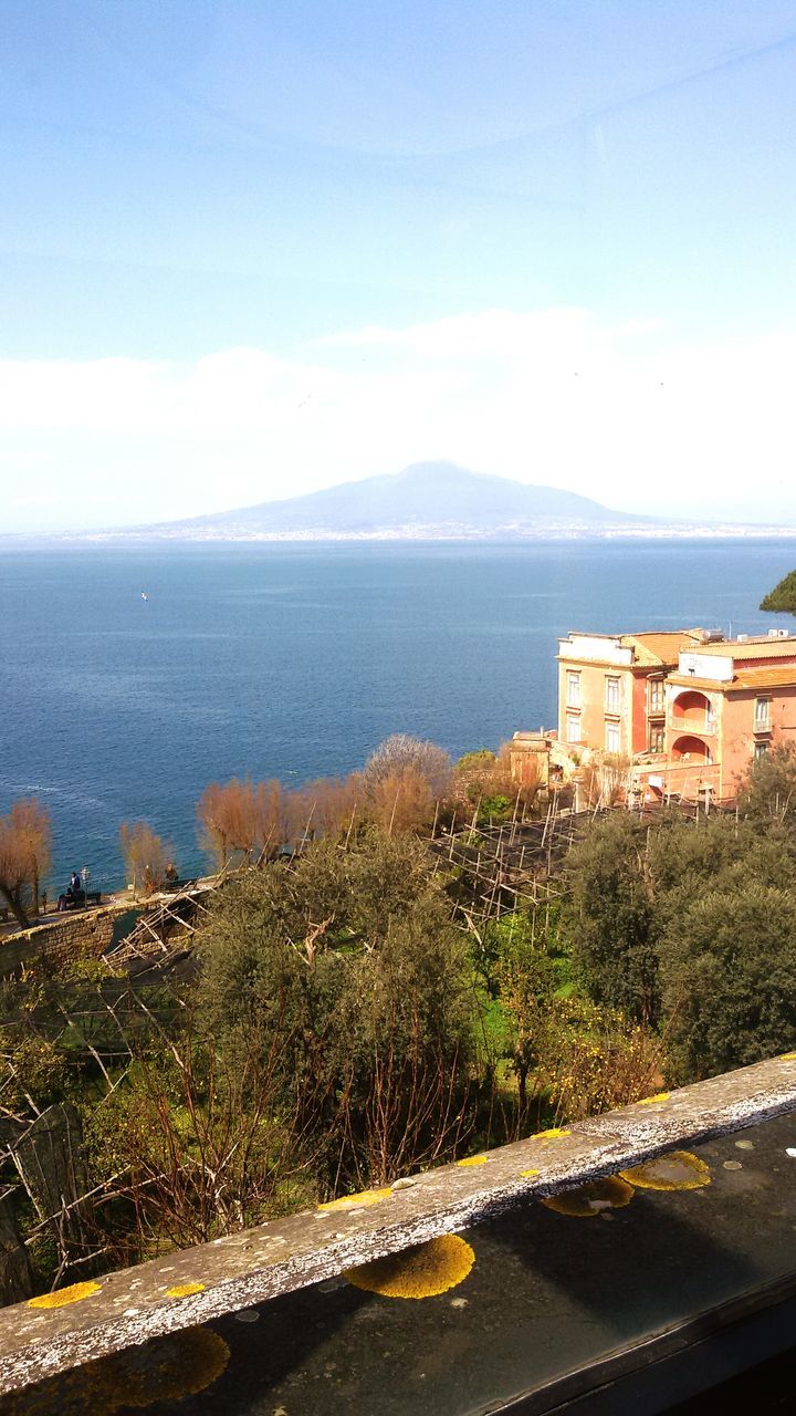 water, sea, sky, mountain, built structure, architecture, building exterior, scenics, tree, nature, horizon over water, beauty in nature, high angle view, tranquil scene, blue, coastline, tranquility, cloud - sky, beach, day